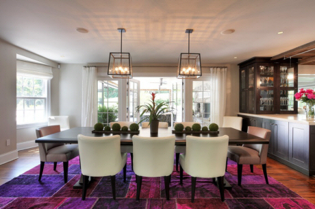 We love how this all white room allows this berry hued Turkish Patchwork rug and minimal accessories to pop in this open dining space. (Photo courtesy of Houzz)