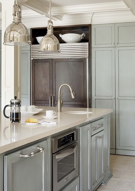 Here this minimal kitchen with industrial lighting is rounded out with rich mouldings and woodwork to add a bit of rich traditionalism to the overall modern feel.
(Photo courtesy of sadieandstella.blogspot.com)